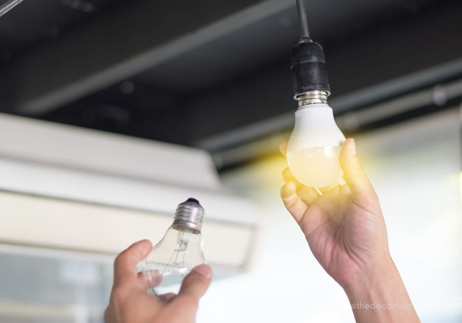 Detailed view of a person cleaning and maintaining ceiling lights, emphasizing the importance of regular care for enhanced longevity and performance.