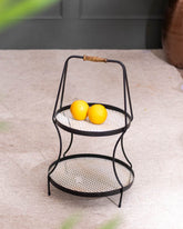 Provence 2-Tier Metal Basket Storage Rack with a rustic black copper finish, displaying vibrant yellow lemons, blending functionality with farmhouse style.
