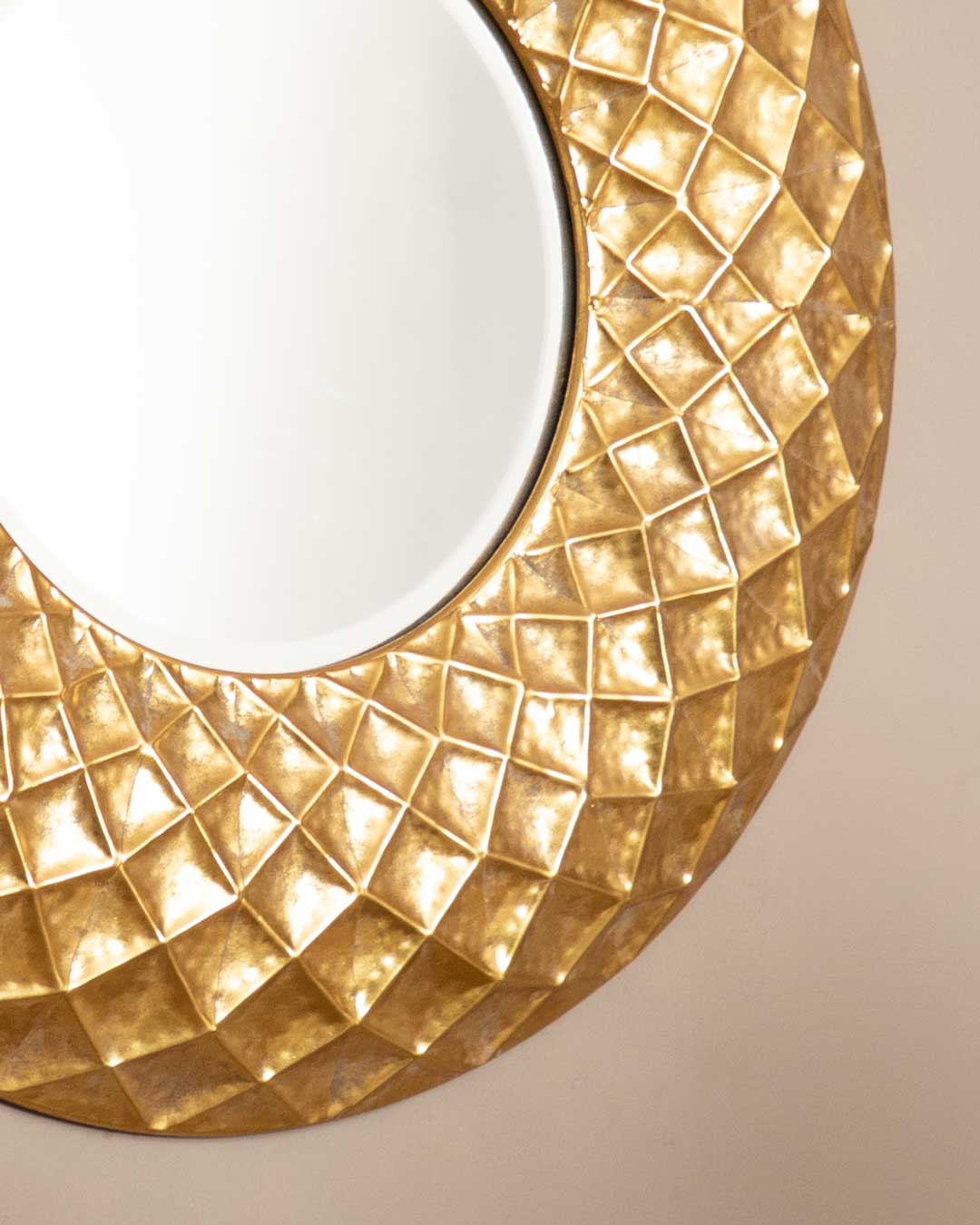 Modern Fractal mirror with a striking gold patterned frame on a simple wall.