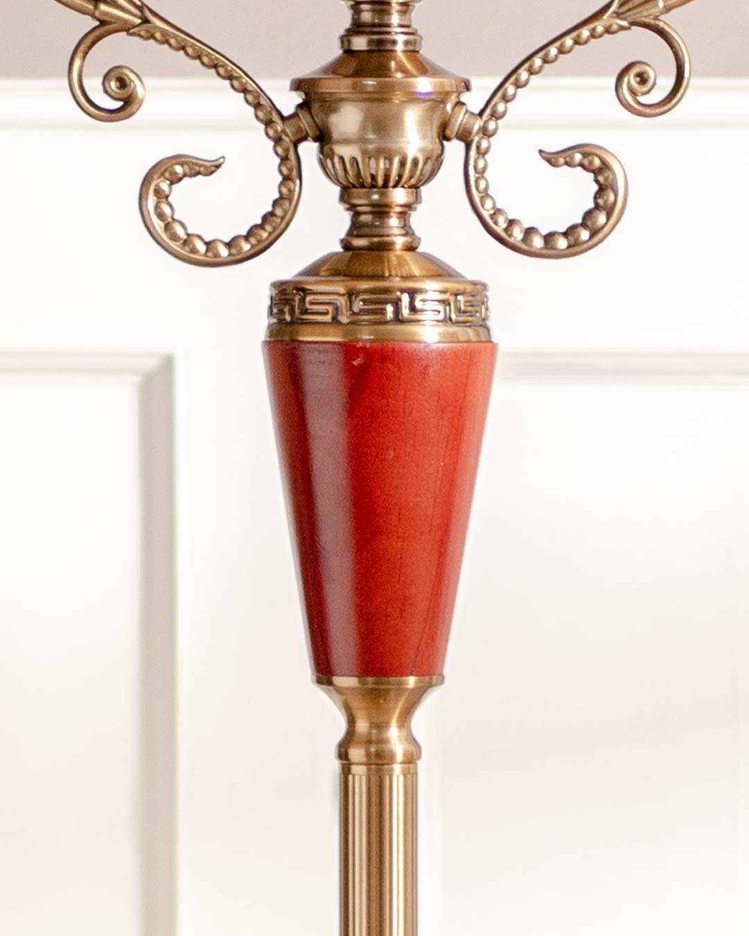 Luxurious 'Seville' decorative clock featuring a glossy red pillar and golden ornamental top, ideal for sophisticated decor.