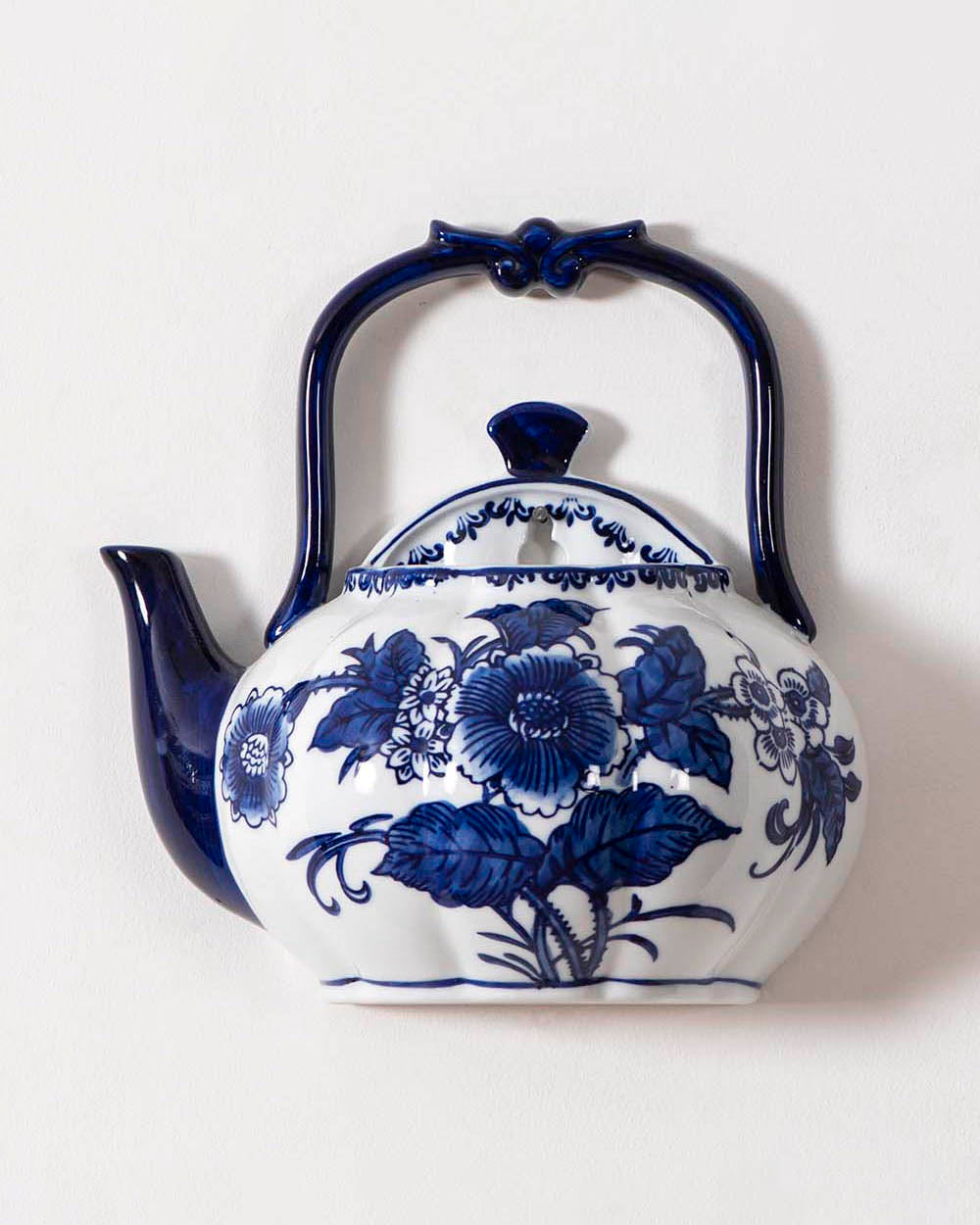 Elegant blue and white porcelain wall-mounted planter kettle with floral design, adding a classic touch to home decor.