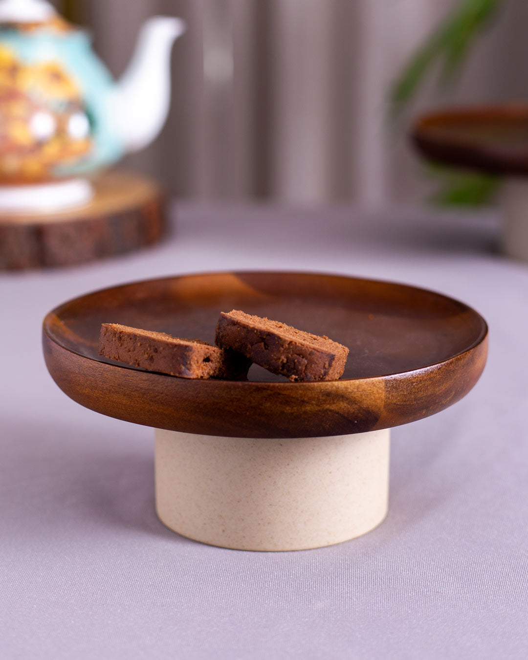 Handcrafted Wooden Rustic Cake Stand being used to serve a delicious cake, emphasizing the stand's practicality and beauty.