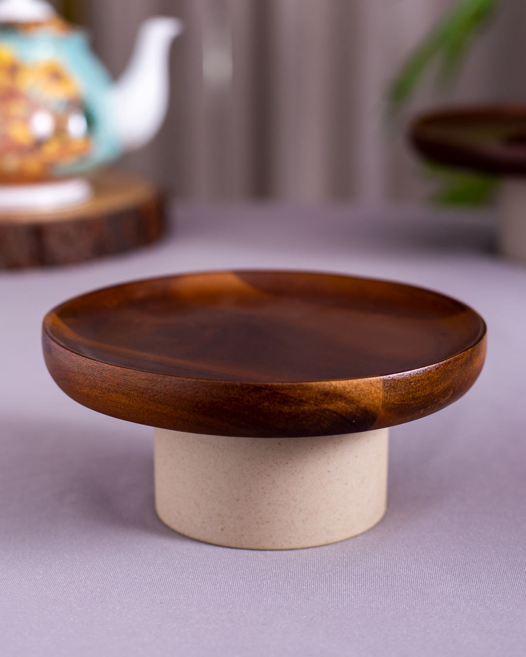 Wooden Rustic Round Cake Stand displayed with citrus fruits, illustrating its use as an attractive centerpiece for dining tables.