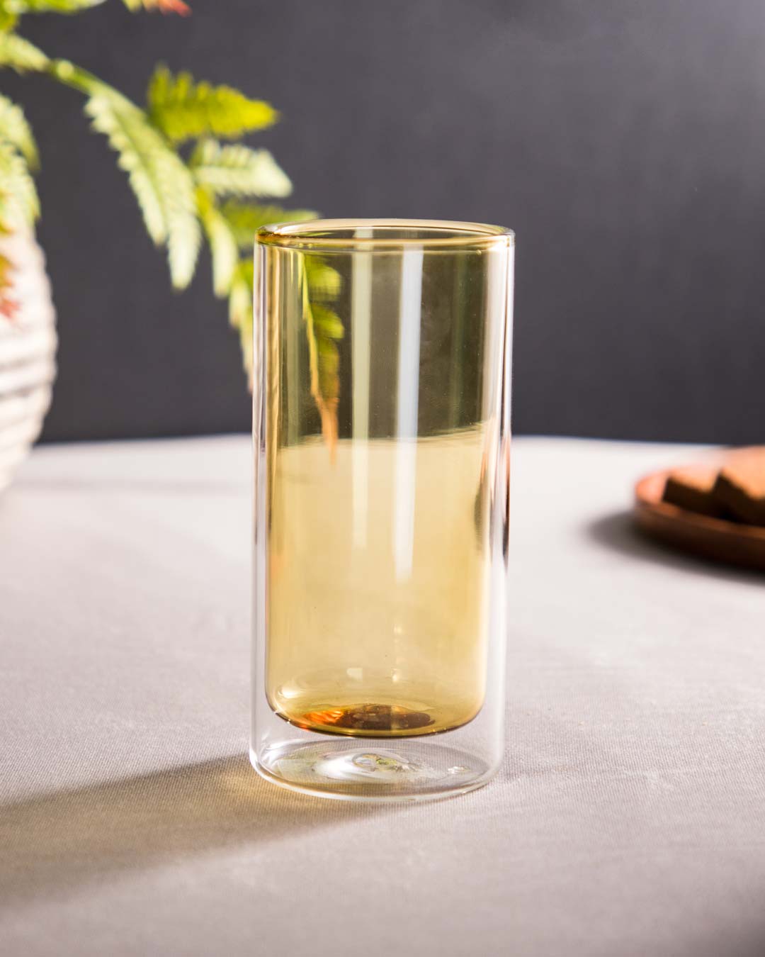 Tall yellow-tinted borosilicate double-wall glass, a modern and stylish choice for serving beverages while keeping them at the desired temperature.