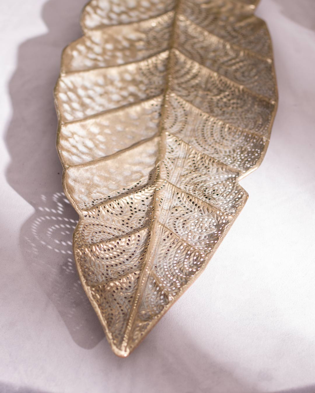 Close-up of leaf detail on metal platter