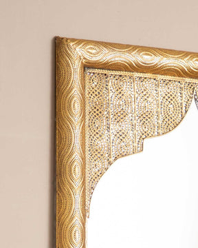 Close-up view of Equator Wall Mirror's ornate gold frame with exquisite craftsmanship.