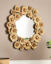 Leafy Radiance mirror adorned with golden metal leaves against a neutral wall.