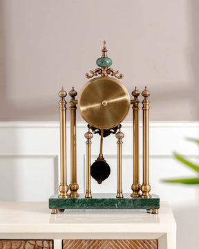 Elegant 'Villa Vista' tabletop pendulum clock with gold finish columns and an emerald green marble base for vintage decor. 