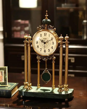 Antique-style 'Villa Vista' brass mantle clock featuring a pendulum, intricate scrollwork, and a classic white dial. 