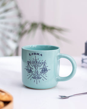 Turquoise Libra zodiac mug with astrological sign illustration, a unique and personalized touch for astrology enthusiasts.