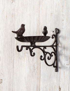 Antique cast iron bird feeder with detailed mallard figurine, ideal for vintage garden decor.